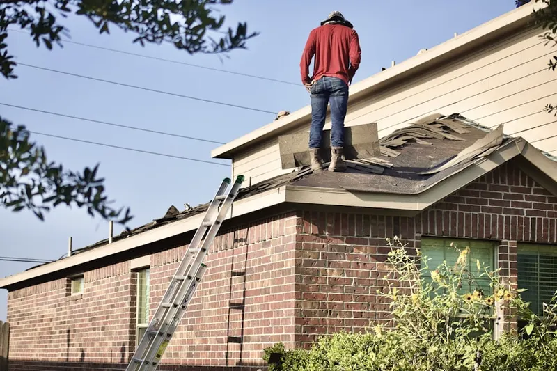 Professional roofer working on a residential roof in Mallard Pond